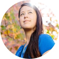 Dr. Rebecca Portnoff stands beneath a vibrant canopy of autumn leaves.